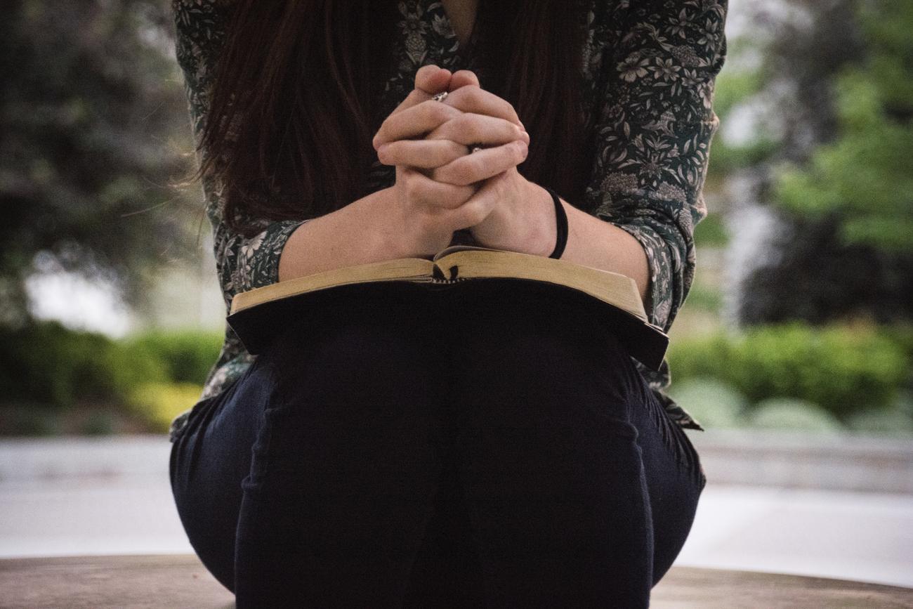 Woman praying with a bible